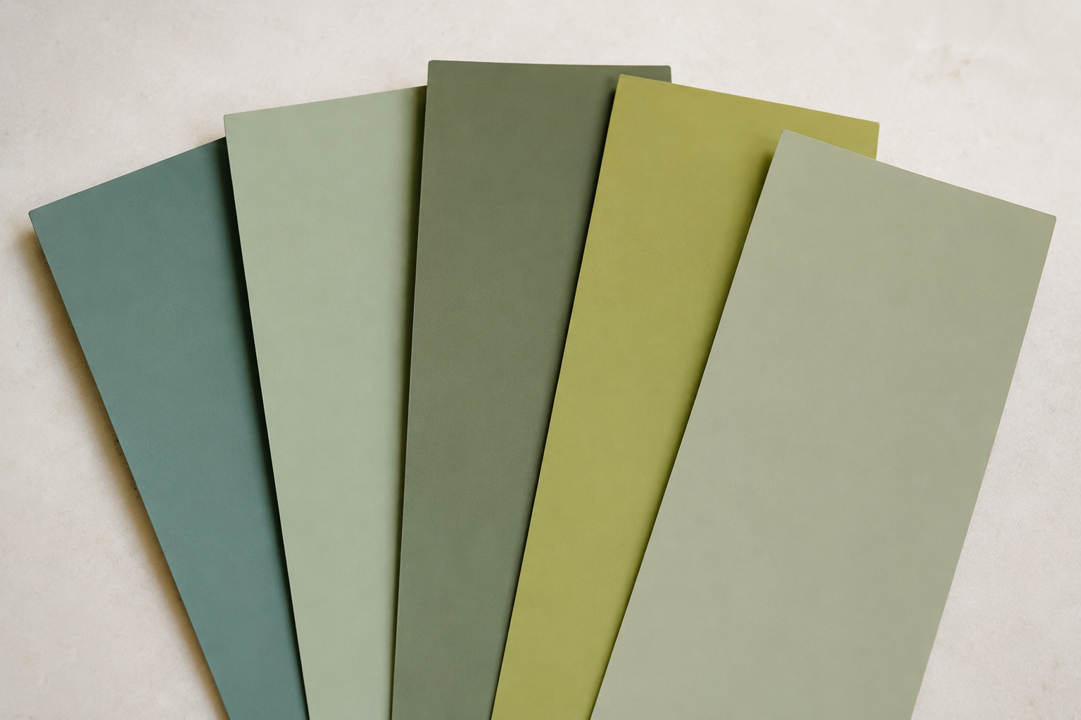 Several green paint swatches with visibly different undertones side by side