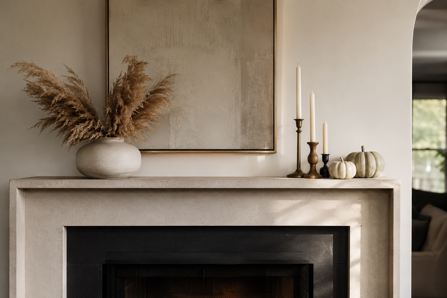 Fireplace mantel styled with dried botanicals, candles, and small pumpkins