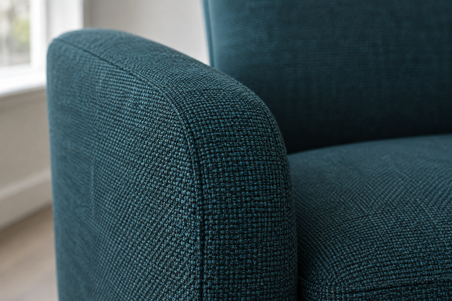Close-up of deep teal performance-weave fabric texture.