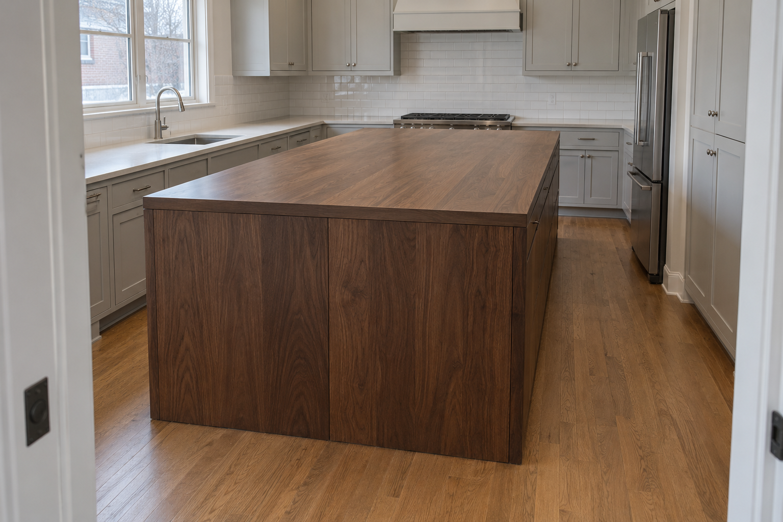 An oversized dark walnut kitchen island crowding the walkway on every side in an ordinary-sized kitchen.