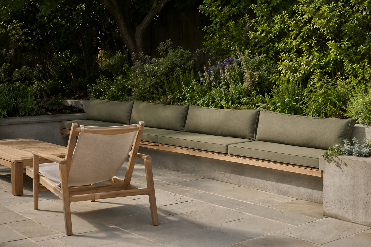 A built-in concrete bench with a teak cap, integrated into a low patio wall