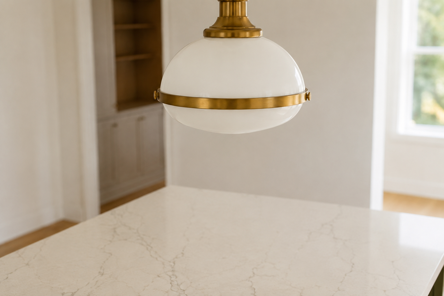 Close detail of the correct clearance between a pendant light and a kitchen island counter