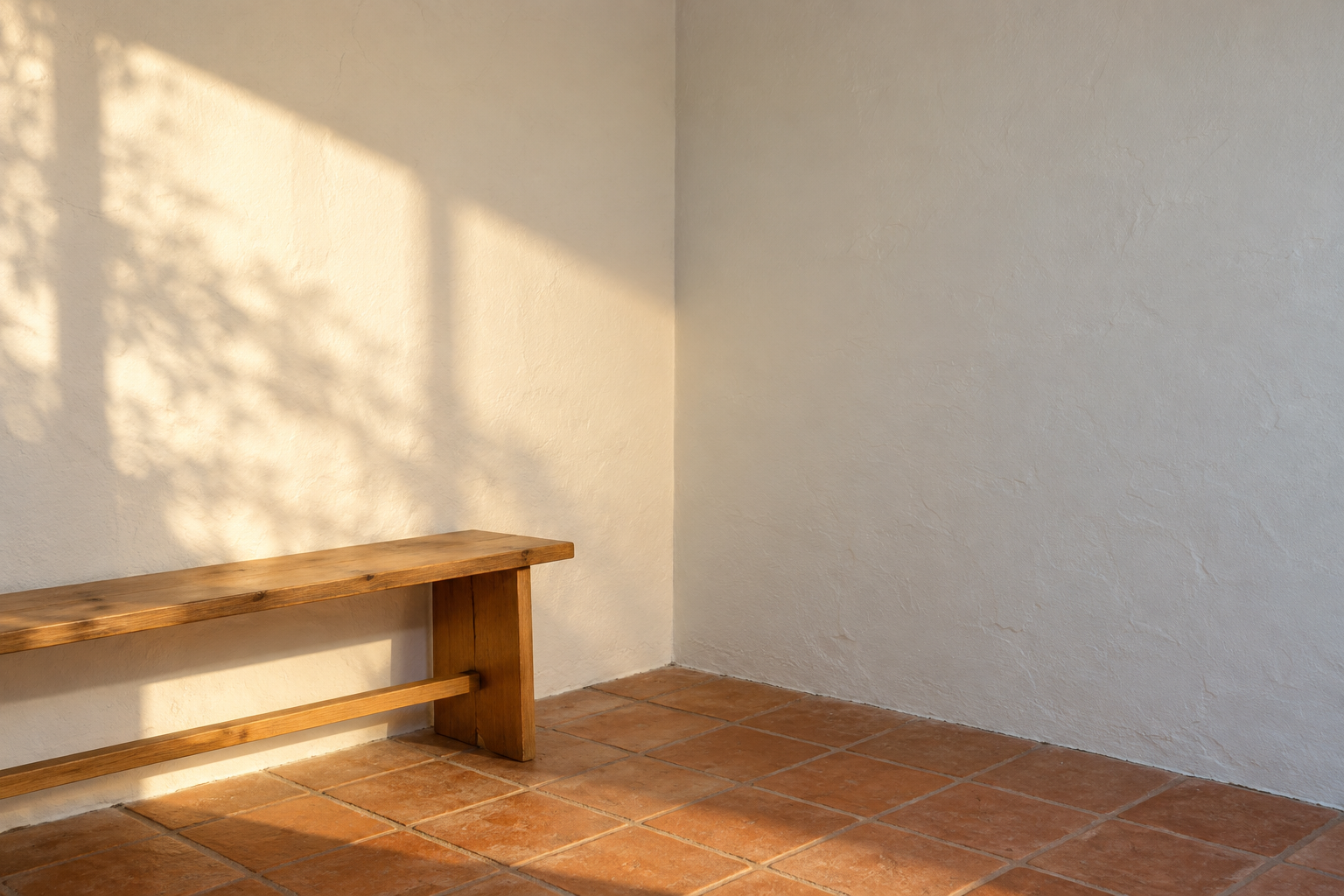The same white paint looking cream on a sunlit wall and gray on a shaded wall in one corner.