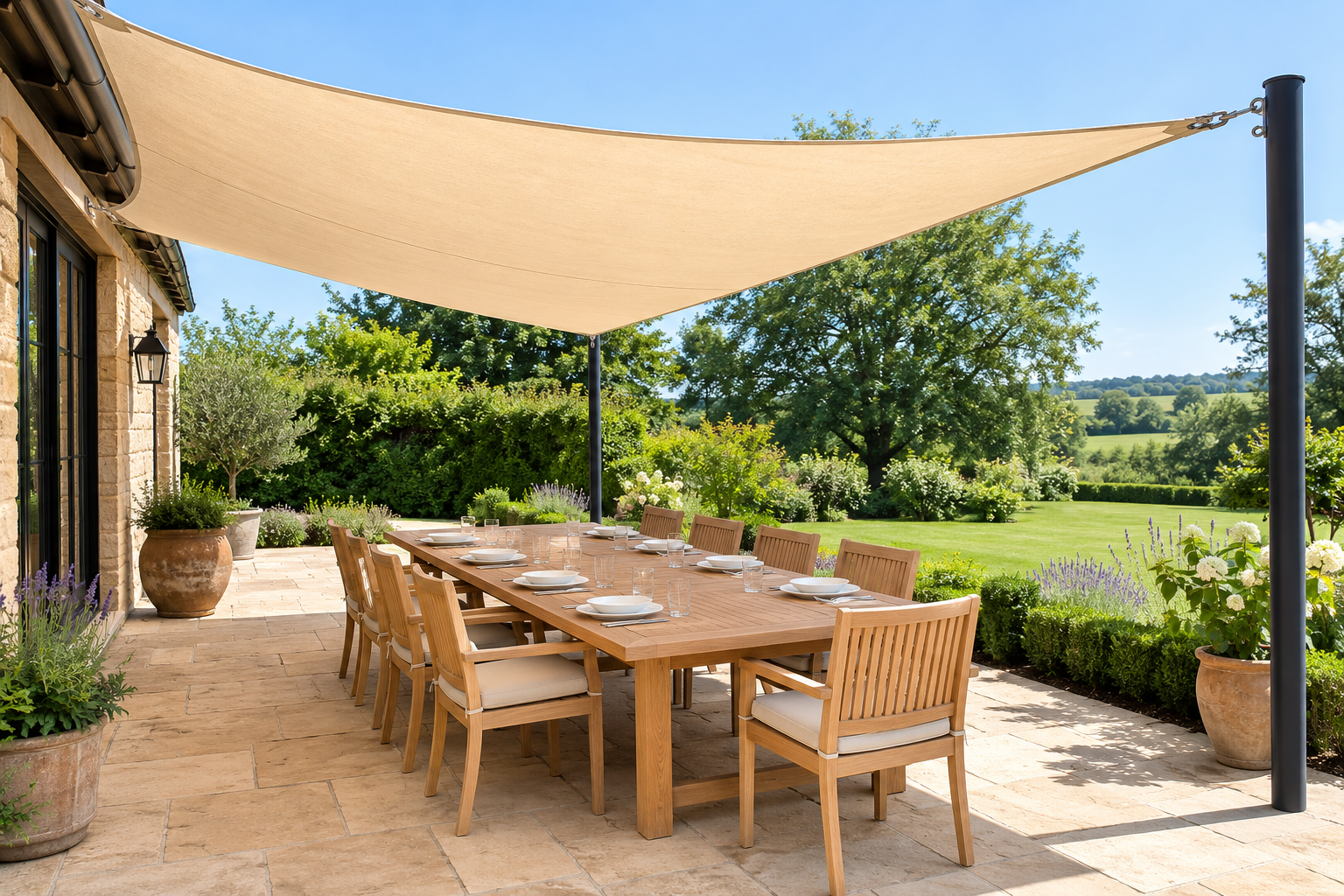 A large paved dining patio shaded by a canvas sail canopy overhead