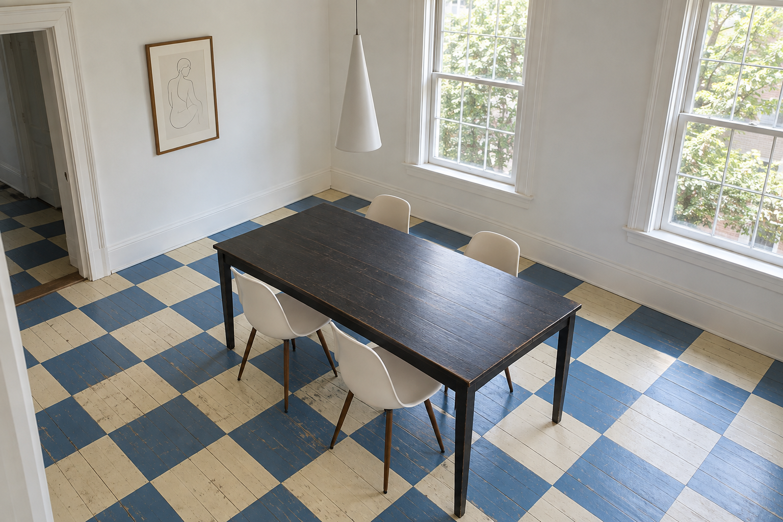 A dining room with floorboards painted in a large cornflower blue and cream checkerboard, worn where the chairs slide, under a black table.