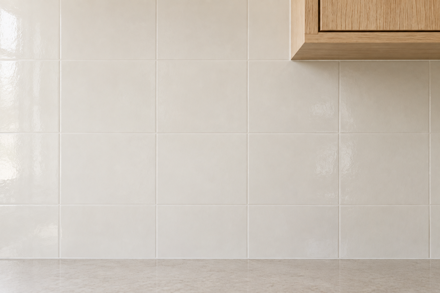 Soft warm white tile with closely matched white grout, joint lines nearly disappearing into one continuous surface.