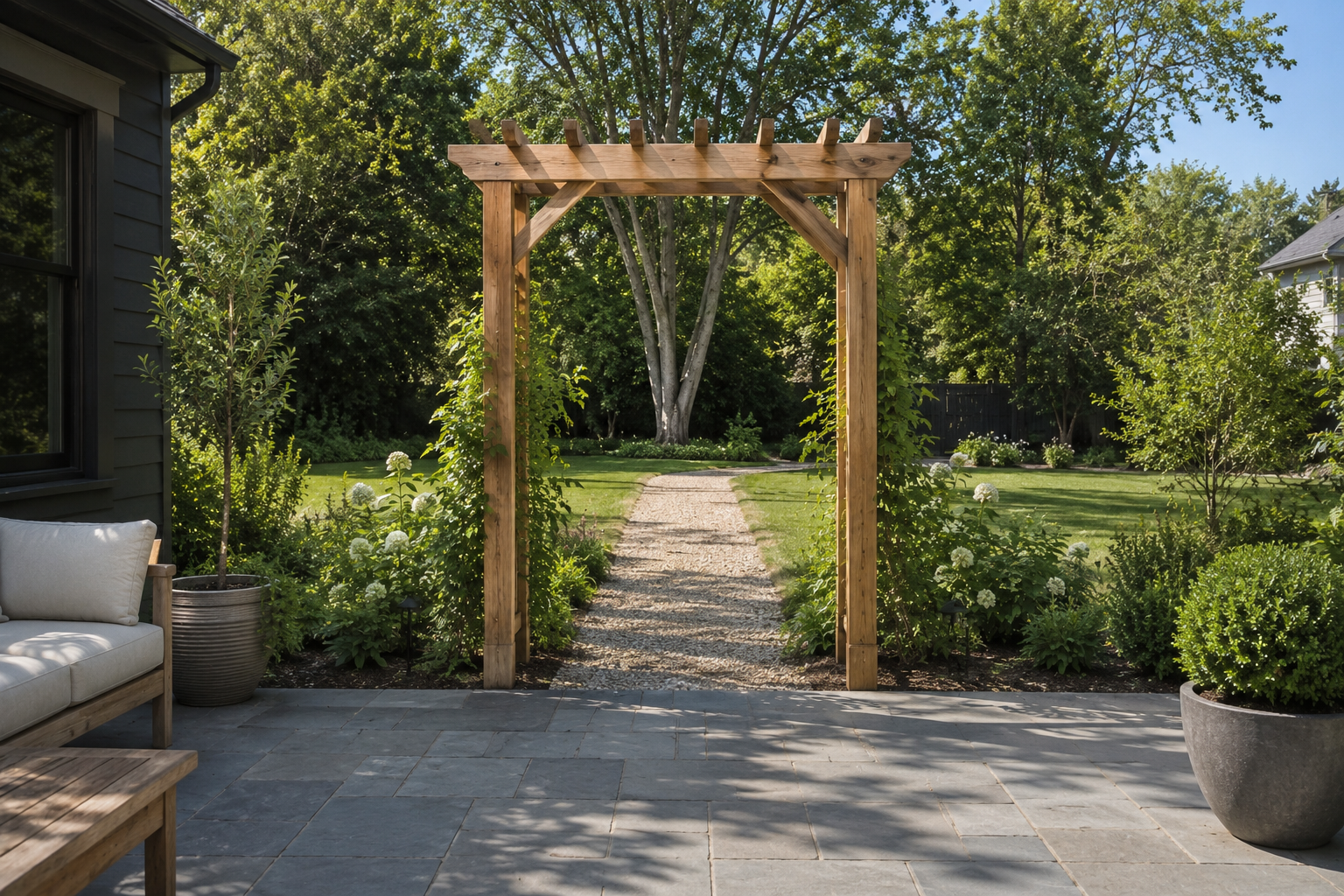 A simple cedar arbor framing the threshold between a patio and the yard beyond