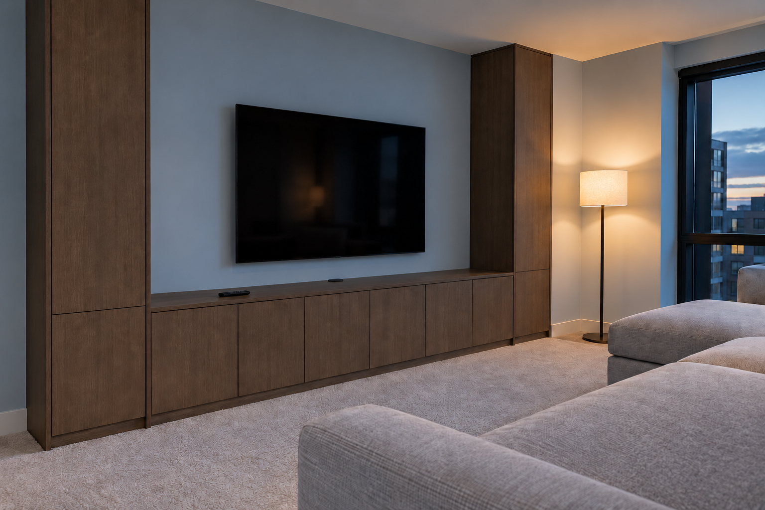 A living room wall of smoked oak cabinets around a wall-mounted TV, with a low run below the screen.