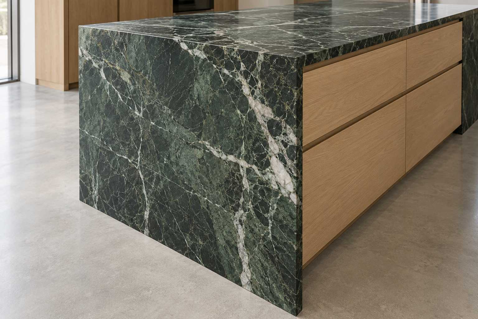 The end of an island where a green veined marble top turns down to the floor, the veins continuing across the corner.
